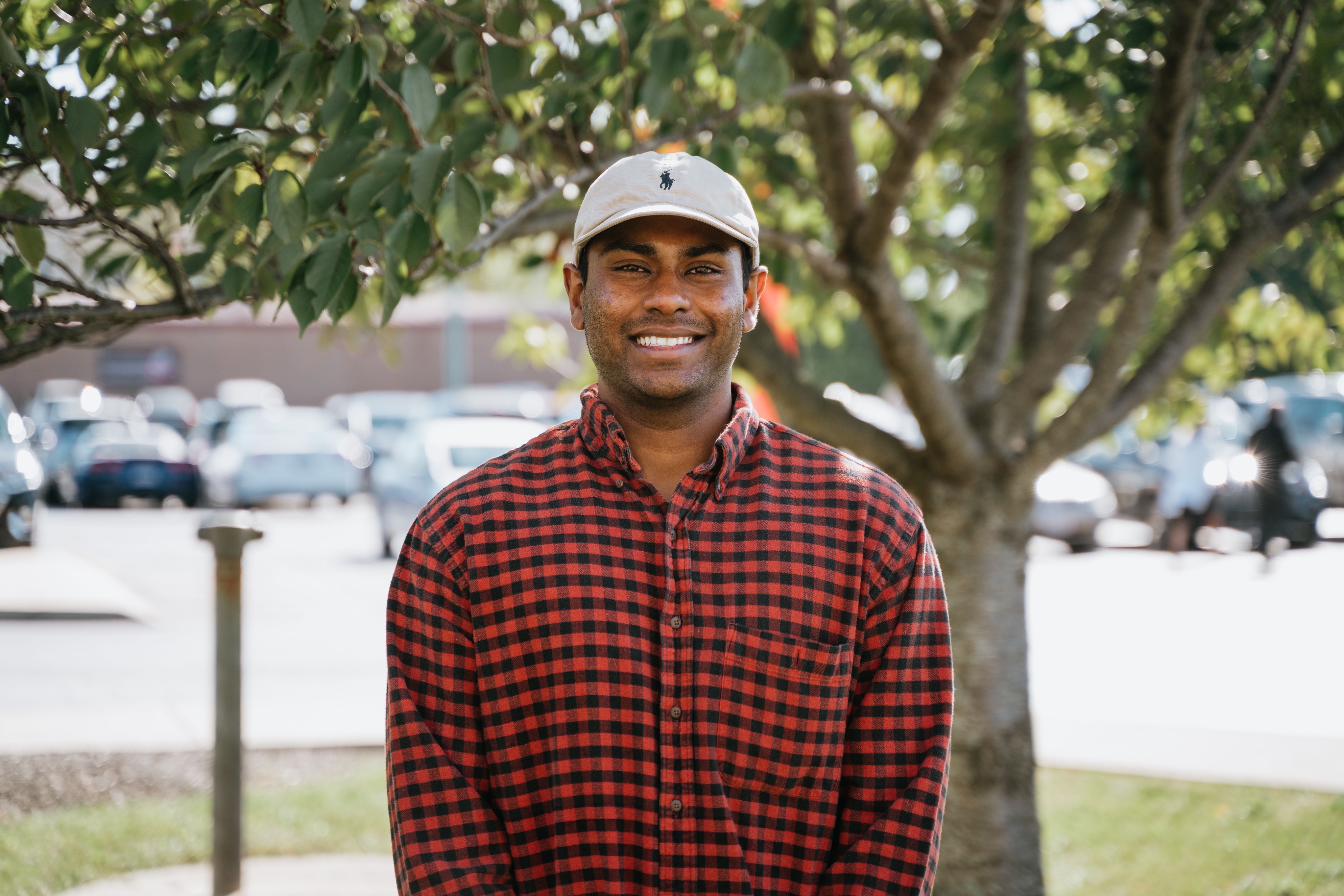 Man taking profile picture in front of tree